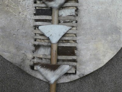Lot 329 - Two 20th Century Zulu Cow Hide Shields, each of tan and white colouring, of elliptical form,...