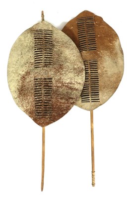 Lot 330 - Two 20th Century Zulu Cow Hide Shields, each of brown roan colouring, of elliptical form, with...