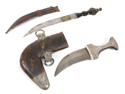 Lot 339 - A 20th Century Omani Jambiya, with 14.5cm double edge curved steel blade, the horn grip with silver