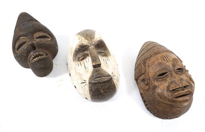 Lot 349 - An Ibibio Wood Mask, covered in a dark granulated pigment, the pierced elliptical eyes with swollen