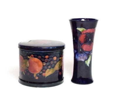 Lot 135 - A William Moorcroft Pansy pattern vase, on a dark blue ground, impressed marks, green painted...