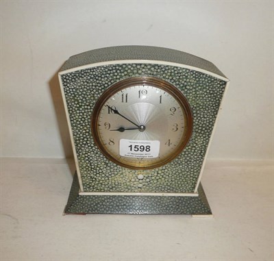 Lot 1598 - An Art Deco Shagreen and Ivory Veneered Table Clock, the shaped case on a stepped base, with...