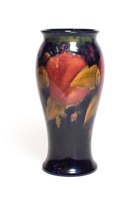 Lot 136 - A William Moorcroft Pomegranate vase, on a blue ground, impressed marks and green painted...