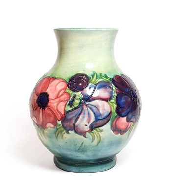 Lot 138 - A Walter Moorcroft Anemone pattern vase, on a blue wash ground, blue painted monogram and impressed