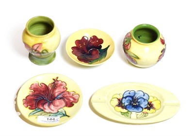 Lot 144 - Group of Walter Moorcroft pottery, all on yellow grounds, including two vases (Bougainvillea...