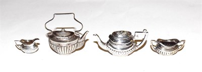 Lot 182 - An Edward VII and Elizabeth II miniature silver toy tea-service, comprising; a kettle, by Levi...