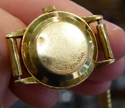 Lot 186 - A lady's 18 carat gold wristwatch signed Omega, Geneve, Ladymatic, with attached mesh bracelet with