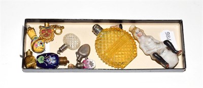 Lot 204 - A group of assorted scent-bottles, in glass or ceramic, with various silvered or metal mounts (9)