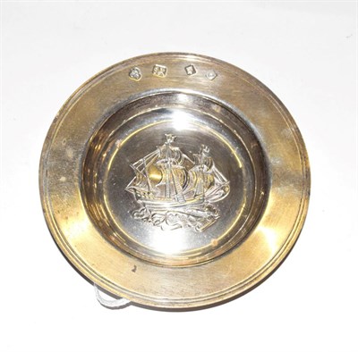 Lot 221 - A silver Armada dish, marked for London, the centre repousse decorated with a triple-masted...