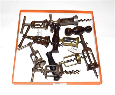 Lot 227 - A collection of eight various corkscrews, including: three with turned wood handle; three 'The...