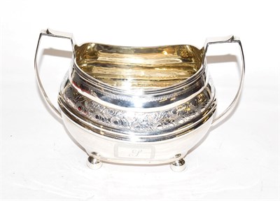 Lot 238 - A George III silver sugar bowl, maker's mark rubbed, London, 1812, oblong and on four ball...