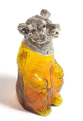 Lot 273 - A silver plate mounted amber glass claret jug in the form of a bear, the silver plate mounts marked