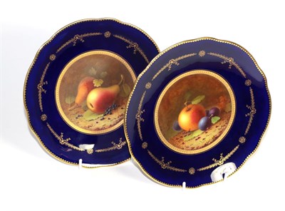 Lot 315 - A pair of Coalport fruit painted plates with cobalt blue borders, each signed F. Howard (each...