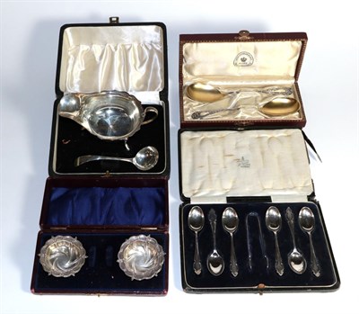 Lot 322 - Four cased silver ttems, comprising: a sauceboat and ladle; a pair of salt-cellars; a set of...