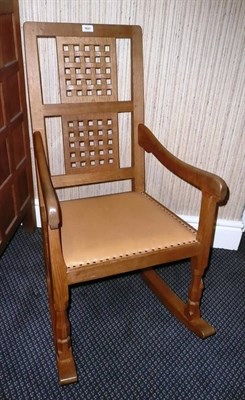 Lot 1621 - A Robert "Mouseman" Thompson Oak Rocking Chair, with two lattice panels back and shaped arms,...