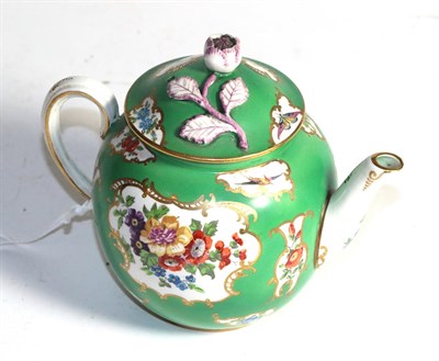 Lot 399 - A 19th century tea pot, painted with vignettes of exotic birds on a green ground, 13cm high