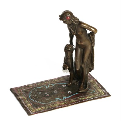 Lot 409 - A Bergman Bronze of a young woman with a seated Panther beside her, upon an Islamic rug