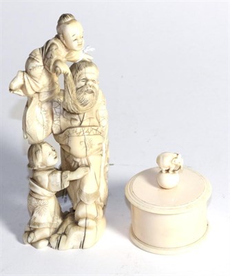 Lot 411 - A 19th century Japanese ivory figure group, 16cm high, and a circular box, 7cm high