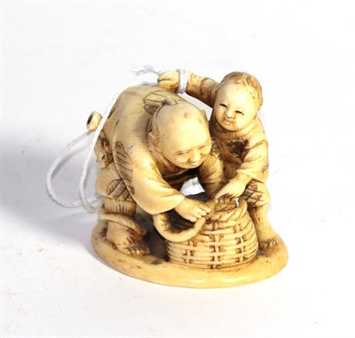 Lot 413 - A Japanese carved ivory figure, late 19th/early 20th century, carved to depict two children...