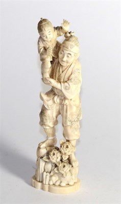 Lot 414 - A Japanese carved ivory figure, late 19th/early 20th century, depicting a man standing on...