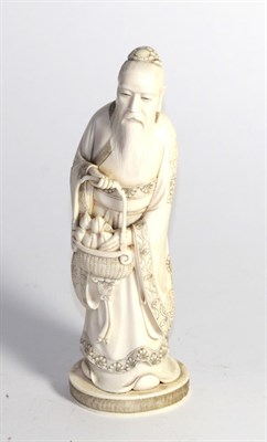 Lot 415 - A Japanese Meiji period ivory okimono of a sage, 23cm high