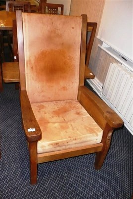 Lot 1626 - A Robert "Mouseman" Thompson Oak Smoker's Chair, with slung leather back, cow-hide covered cushion