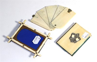 Lot 429 - An Edwardian ivory aide memoir, an Edwardian ivory notebook and an Edwardian ivory photograph frame