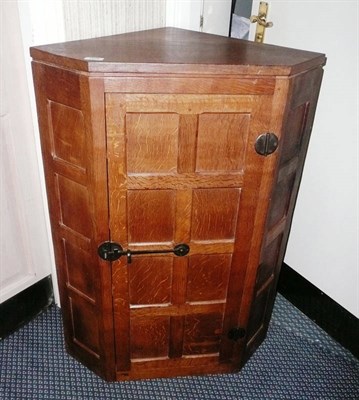 Lot 1628 - A Robert "Mouseman" Thompson Panelled Oak Hanging Corner Cupboard, with fitted shelved...