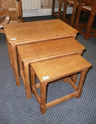 Lot 1629 - A Robert "Mouseman" Thompson Oak Nest-of-Tables, on four octagonal legs, each with carved mouse...