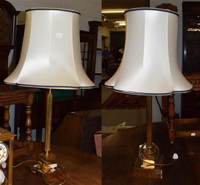 Lot 469 - A modern brass columnar table lamps with shades, base and fitting 55cm high