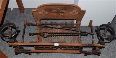 Lot 533 - A cast iron fire grate, andirons and tools, the grate decorated with fleur de lis