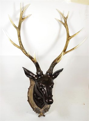 Lot 1051 - A Model of Red Deer head mount on faux shield with faux antlers, 14 points, widest span 69cm,...