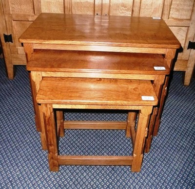 Lot 1645 - A Robert "Mouseman" Thompson Oak Nest-of-Tables, on four octagonal legs, each with carved mouse...