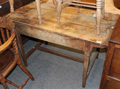 Lot 1176 - An early 19th century farmhouse kitchen table with scrubbed top, 125cm by 63cm by 72cm