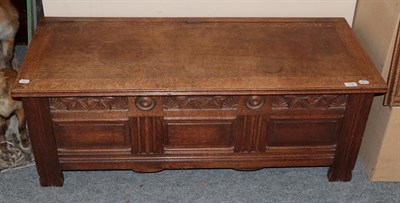 Lot 1197 - A 20th century oak blanket box with three moulded panels