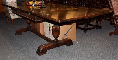 Lot 1211 - A 1920s oak drawer-leaf dining table with trestle base