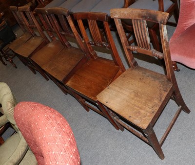 Lot 1224 - A matched set of six oak plank seated chairs