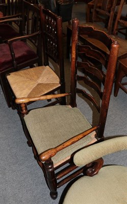 Lot 1229 - A 19th century elm ladder back low armchair, together with a spindle back armchair of similar...