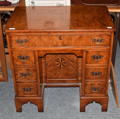 Lot 1235 - A reproduction inlaid burr walnut kneehole desk, 76cm by 48cm by 76cm
