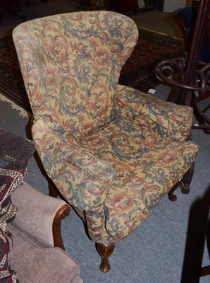 Lot 1245 - A George III style wing back armchair