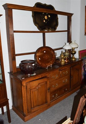 Lot 1256 - An oak Cumberland dresser with plate rack, 184cm by 48cm by 196cm