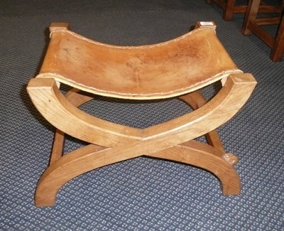 Lot 1665 - A Peter "Rabbitman" Heap Oak Cross-Frame Stool, leather seat, with carved rabbit signature, 40cm