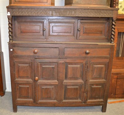 Lot 1270 - An early 18th century carved and panelled oak court cupboard, initialled T.H.M dated 1717 154cm...