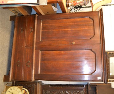 Lot 1274 - An 18th century oak press cupboard with dentil corners, the interior with three sliding trays,...