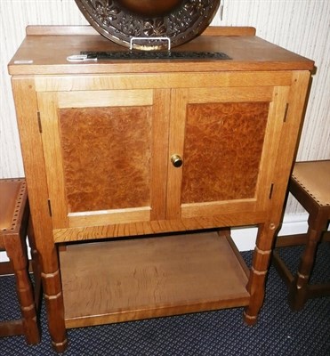 Lot 1668 - A Malcolm "Foxman" Pipes Burr Oak Panelled Cupboard, with raised upstand above two cupboard...