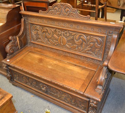 Lot 1306 - A late Victorian carved oak box settle, 125cm by 52cm by 103cm together with a Regency mahogany...