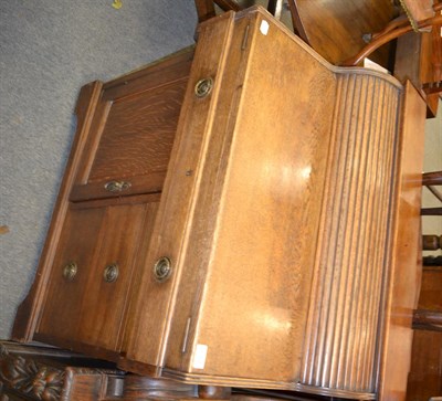 Lot 1307 - A circa 1920's oak writing desk, the drawer connected to a tambour mechanism, opening to reveal...