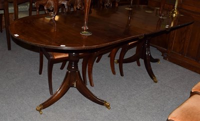 Lot 1333 - A Regency style mahogany twin-pedestal dining table with additional leaf