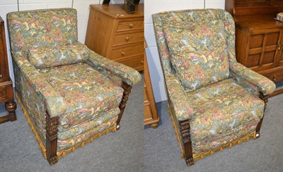 Lot 1356 - A pair of early 20th century carved oak armchairs, later recovered in floral fabric