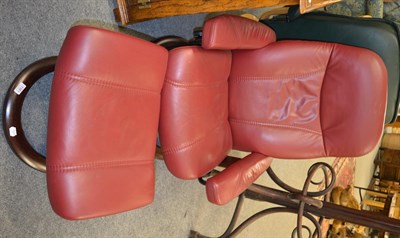 Lot 1361 - An Ekornes bentwood red upholstered Stressless recliner with footstool